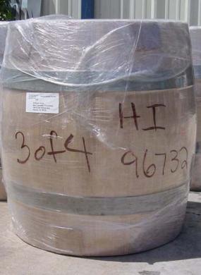 Three barrels wrapped in plastic wait to be converted into taiko